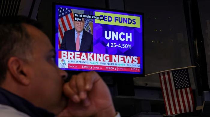 Fed holds rates steady, cites rising inflation risks